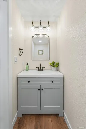 a bathroom with a sink vanity and mirror