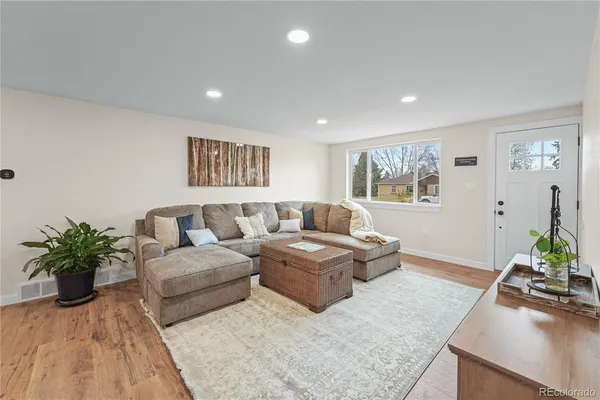 a living room with furniture potted plant and a window