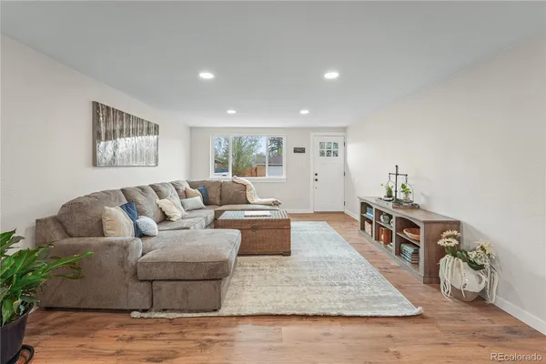 a living room with furniture and wooden floor