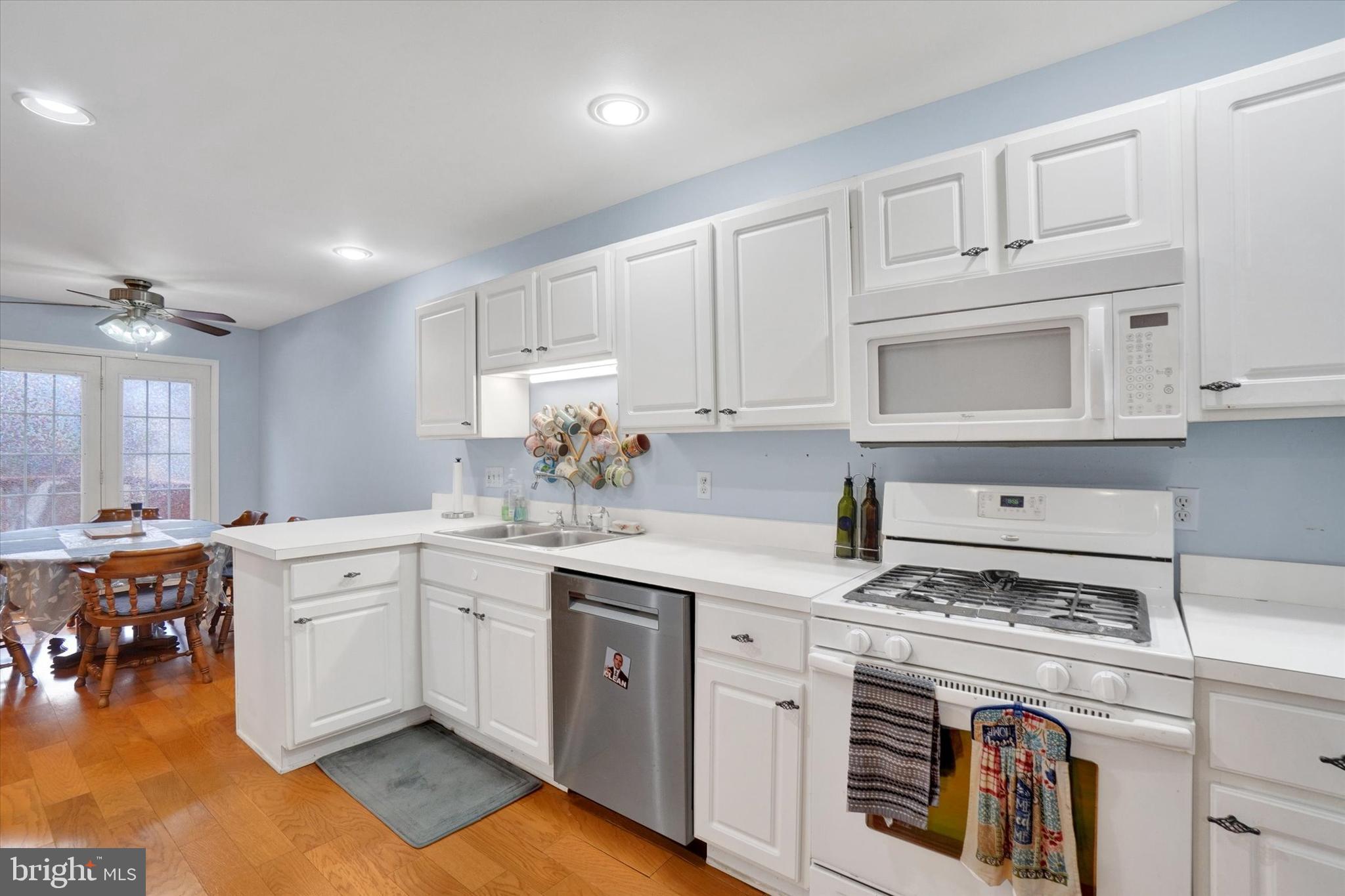 115 Oak Ridge Lane, Unit 115 Dallastown, PA 17313 - Photo 11 of 32 a kitchen with a stove a sink and cabinets