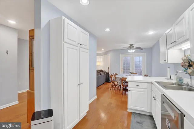 a large white kitchen with lots of counter space and windows