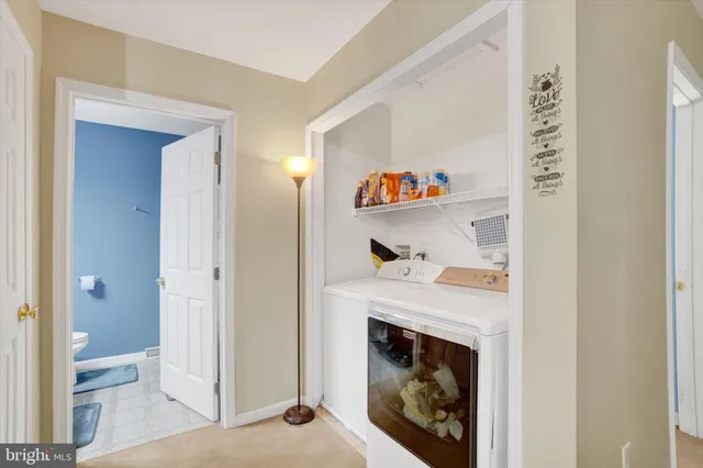 a view of a livingroom with workspace and a couch