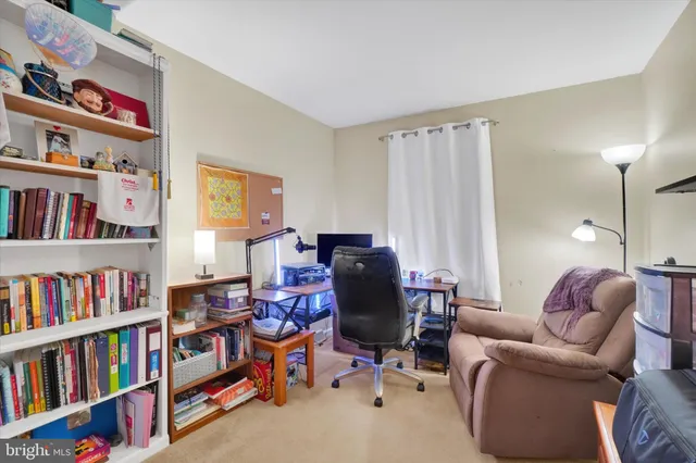 a livingroom with a book shelf with a living room