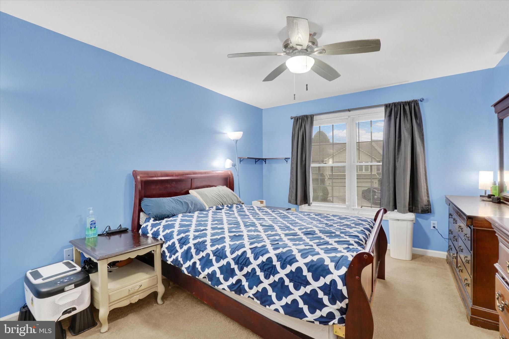 115 Oak Ridge Lane, Unit 115 Dallastown, PA 17313 - Photo 19 of 32 a bedroom with a bed and window