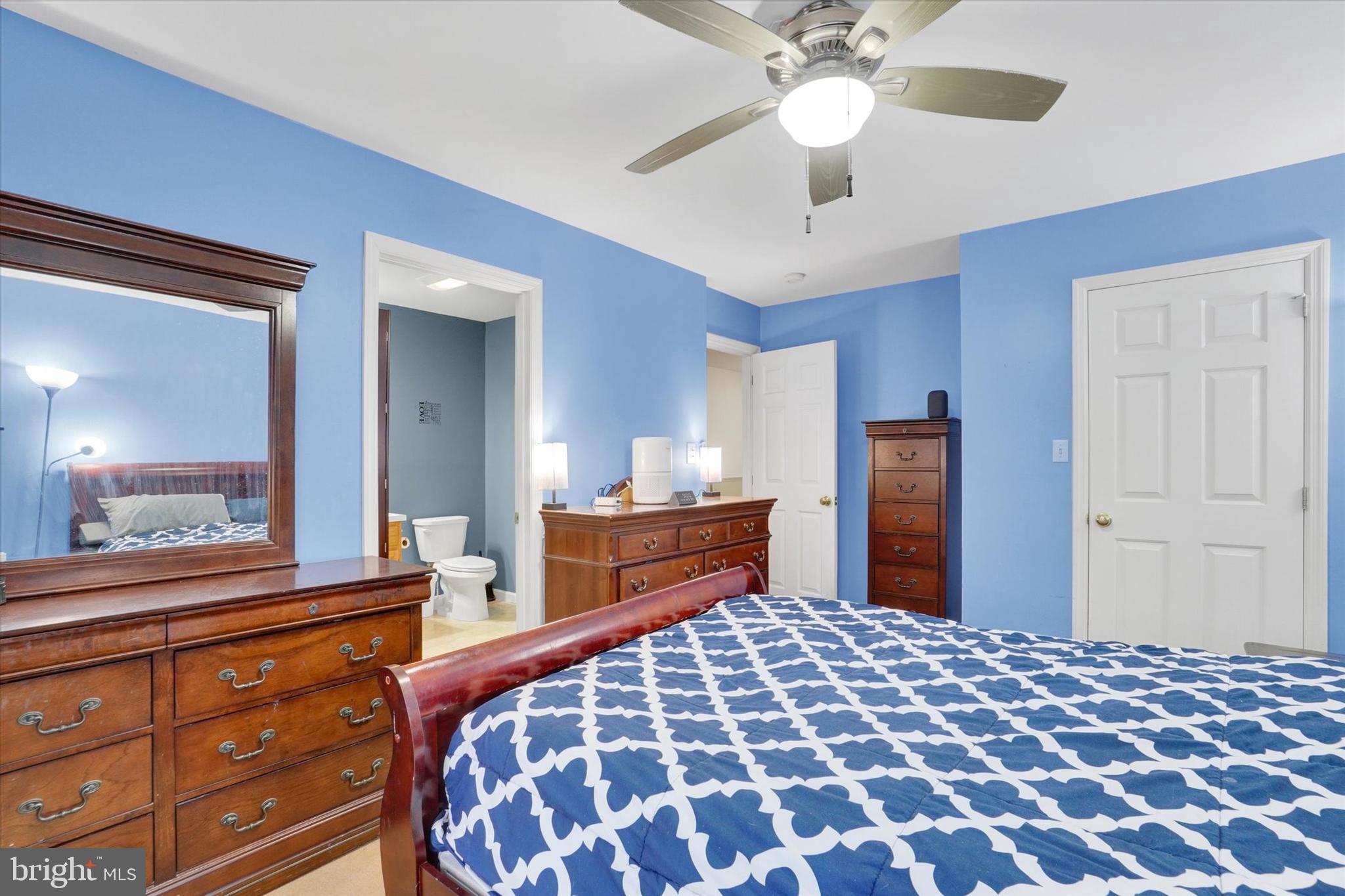 115 Oak Ridge Lane, Unit 115 Dallastown, PA 17313 - Photo 20 of 32 a bedroom with a bed and a chandelier