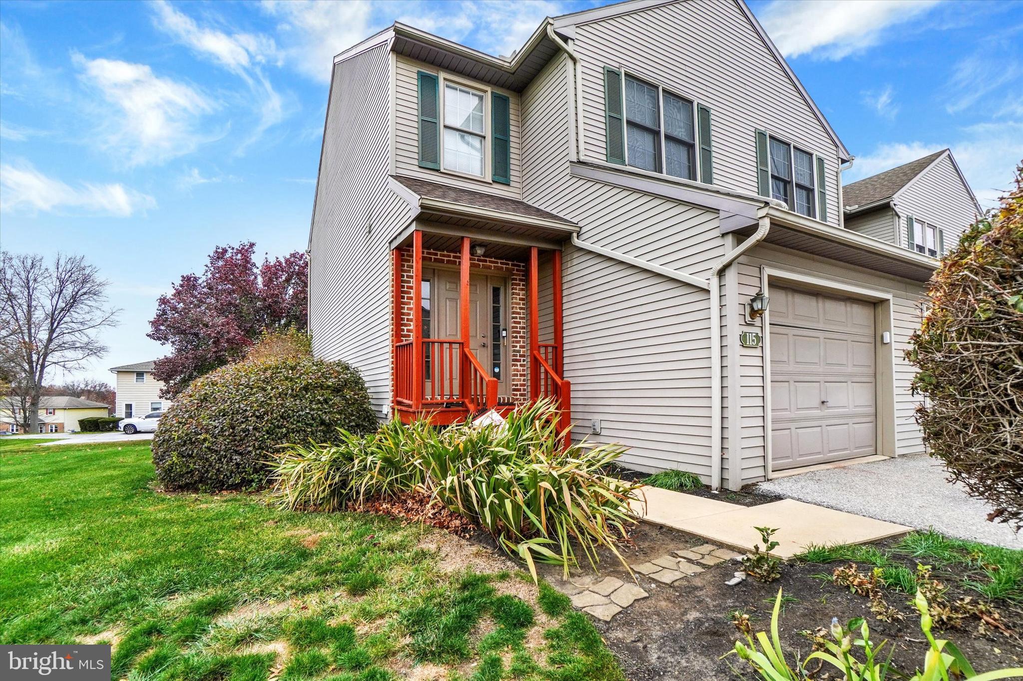 115 Oak Ridge Lane, Unit 115 Dallastown, PA 17313 - Photo 2 of 32 a front view of a house with a garden