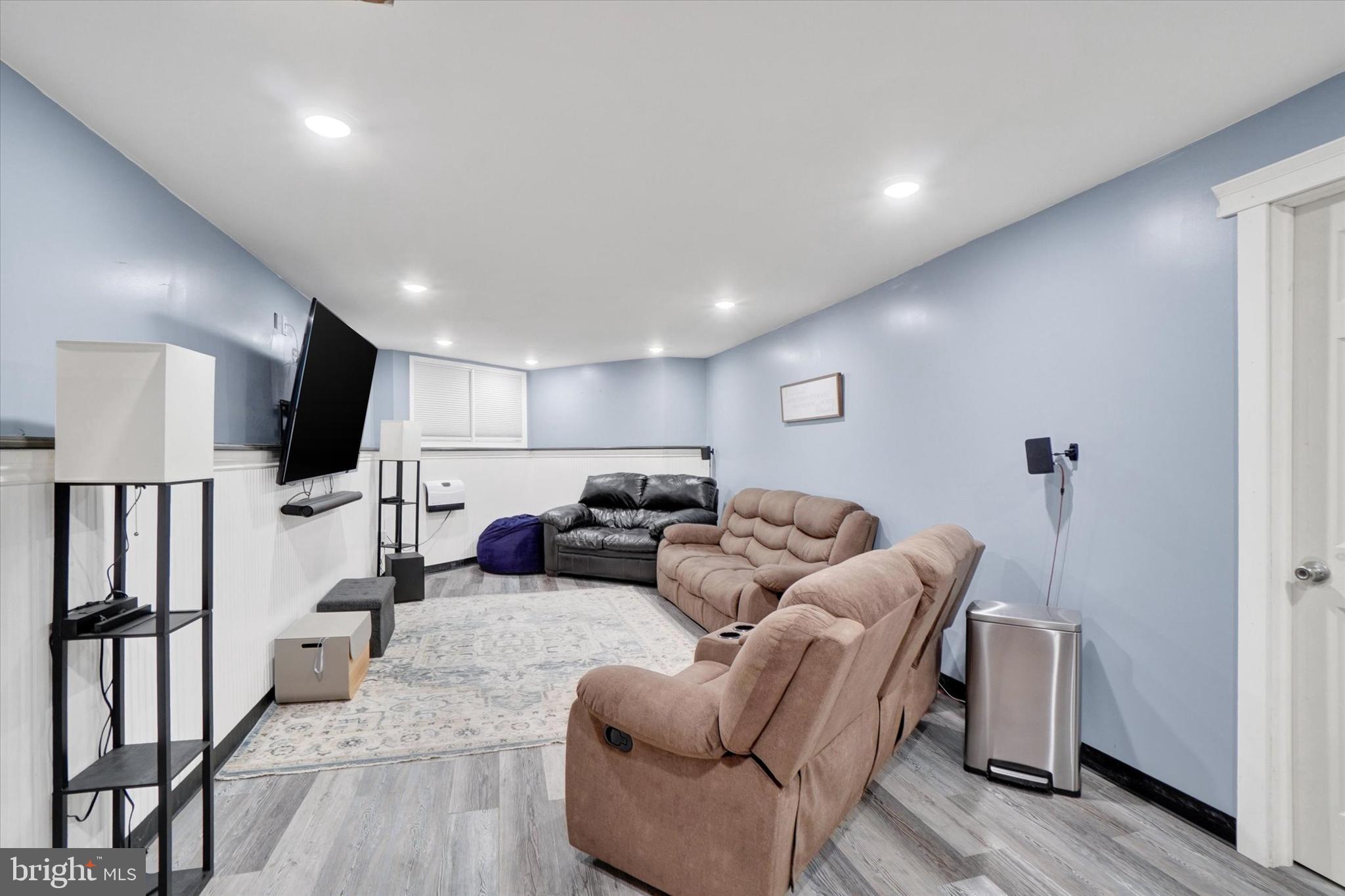 115 Oak Ridge Lane, Unit 115 Dallastown, PA 17313 - Photo 23 of 32 a living room with furniture wooden floor and a flat screen tv