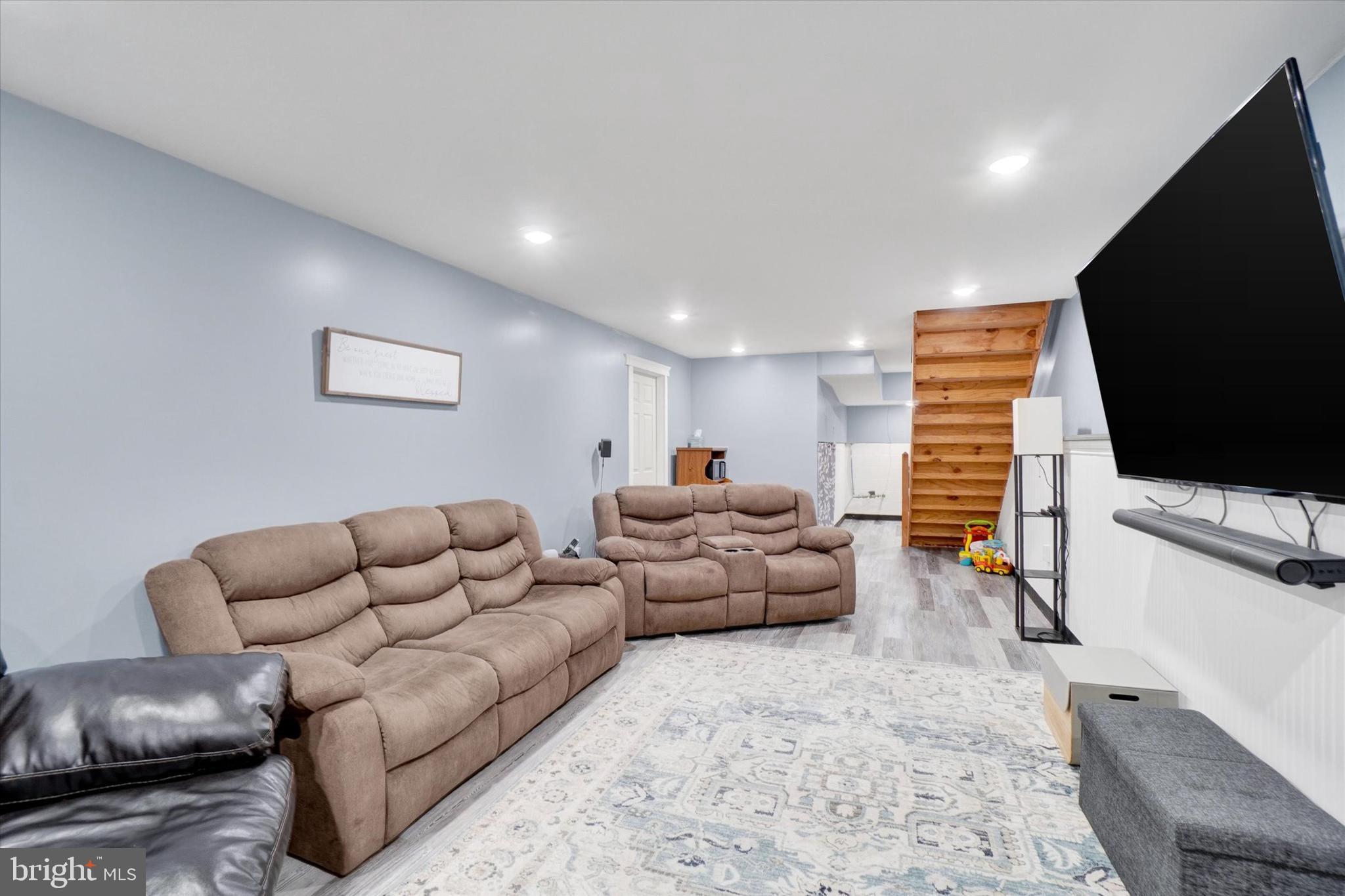 115 Oak Ridge Lane, Unit 115 Dallastown, PA 17313 - Photo 24 of 32 a living room with furniture and a flat screen tv