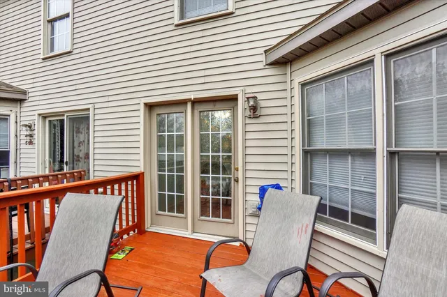 a view of a balcony with wooden floor and fence