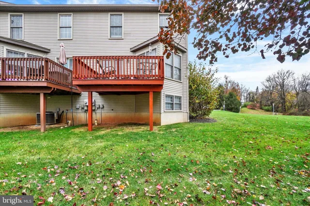 a view of a house with a yard and sitting area