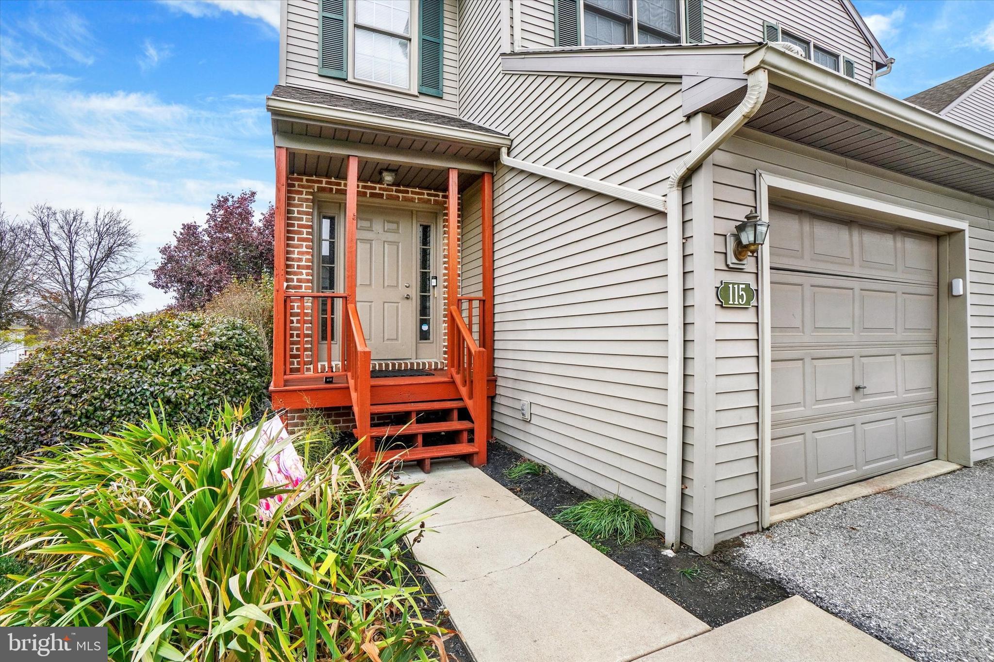 115 Oak Ridge Lane, Unit 115 Dallastown, PA 17313 - Photo 3 of 32 a front view of a house with a yard