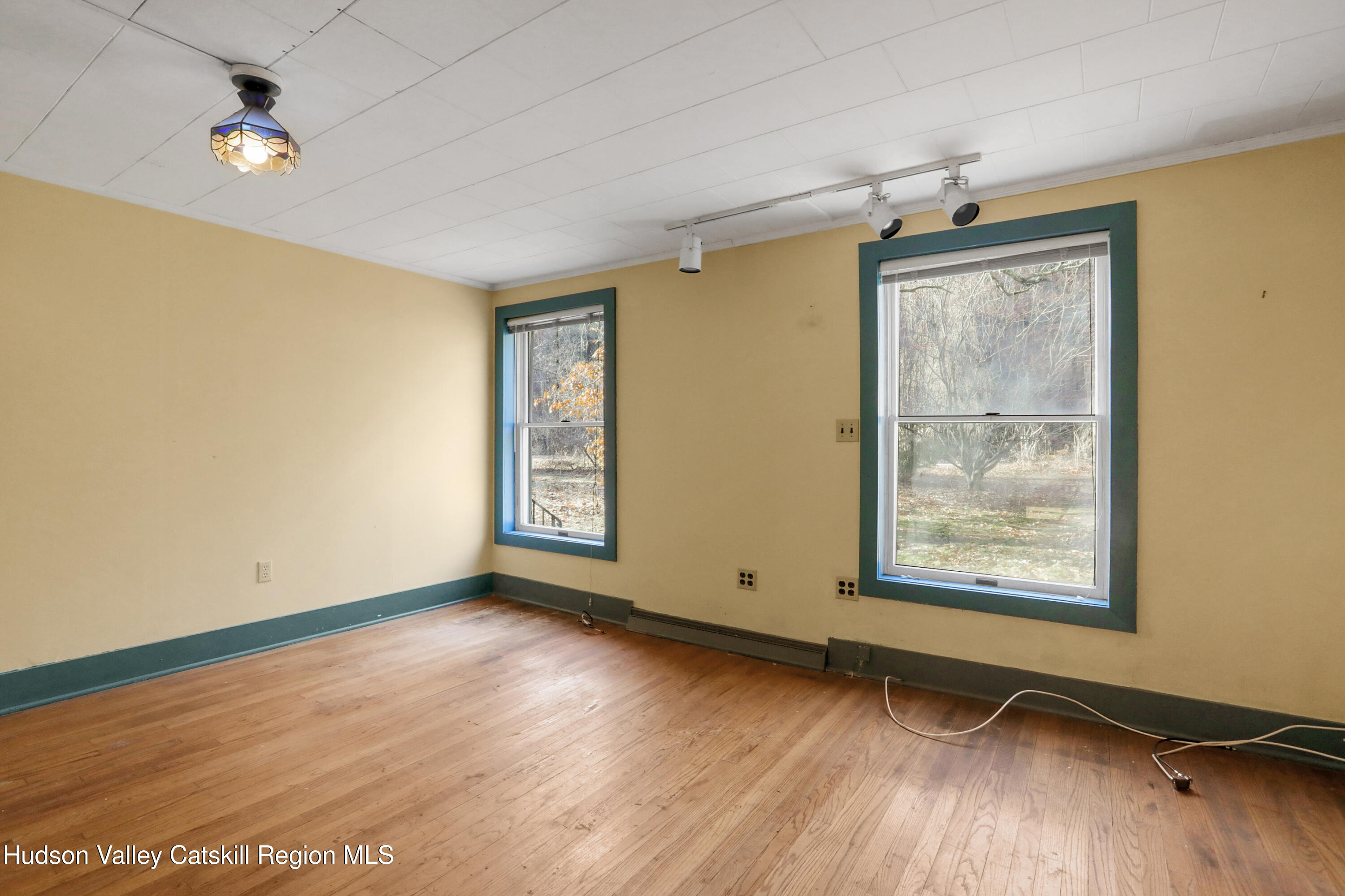 62 Andrew Lane Shandaken, NY 12457 - Photo 16 of 30 an empty room with wooden floor fan and windows