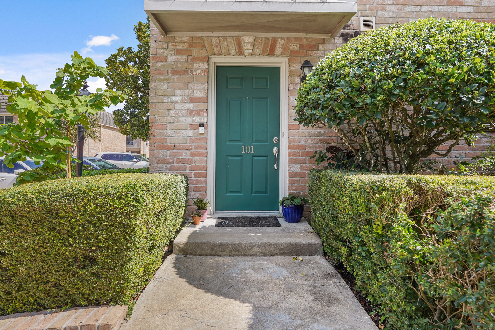 2236 South Piney Point Road, Unit 101 Houston, TX 77063 - Photo 2 of 21 a front view of a house with a garden