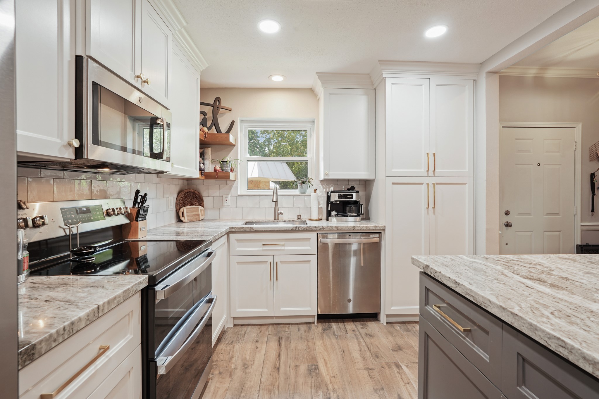 2236 South Piney Point Road, Unit 101 Houston, TX 77063 - Photo 5 of 21 a kitchen with a sink stove and cabinets