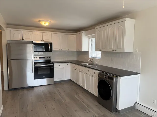 a kitchen with a refrigerator sink and cabinets