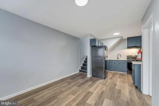 a view of a kitchen with a sink and a refrigerator