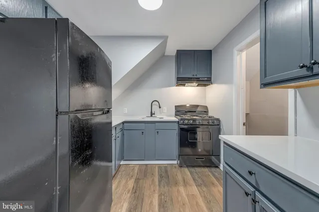 a kitchen with a sink stove and refrigerator