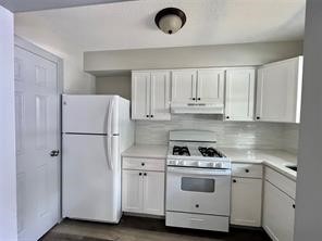 8335 Bonner Drive, Unit 3 Houston, TX 77017 - Photo 1 of 11 a kitchen with white cabinets and white appliances