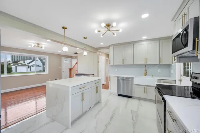 a kitchen with a sink stove and cabinets