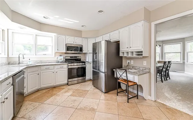 a kitchen with granite countertop a sink and cabinets