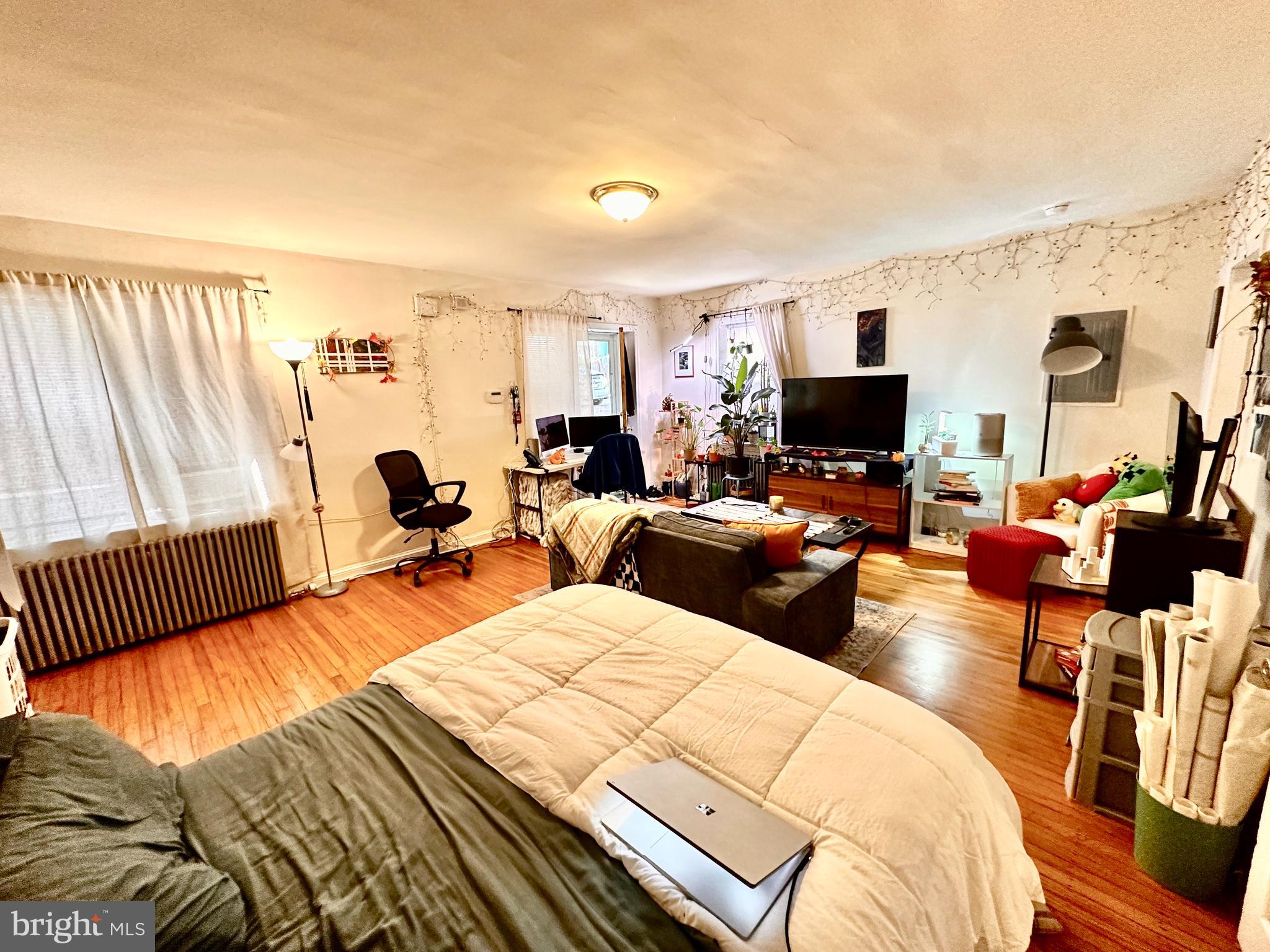 243 West Rittenhouse Street, Unit 2C Philadelphia, PA 19144 - Photo 4 of 9 a bed room with two bed and a television