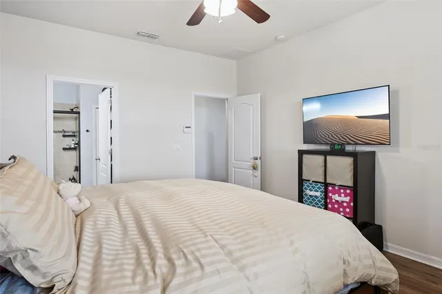 a bedroom with a bed and a chandelier