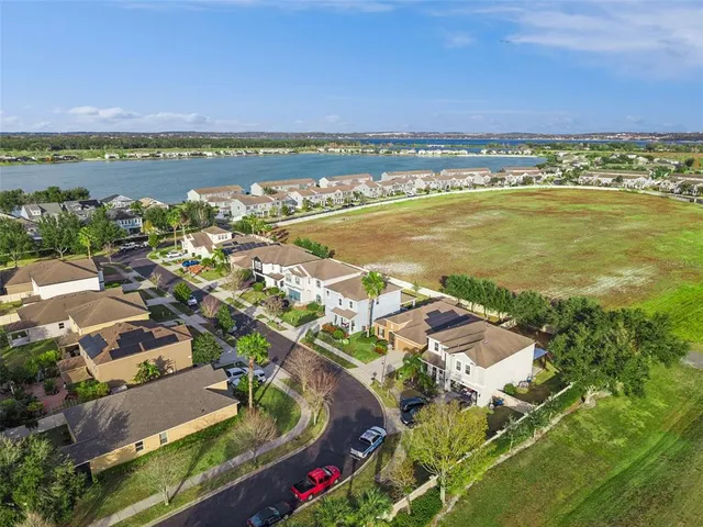 an aerial view of residential building and lake