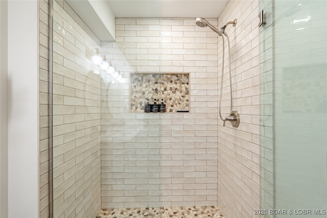 999 Imperial Point Drive Four Seasons, MO 65049 - Photo 46 of 74 New walk in shower w/custom tile in guest bath low