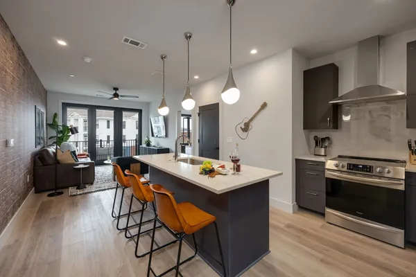 a stove top oven sitting inside of a kitchen