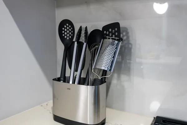 a kitchen with stainless steel appliances a refrigerator a sink and wooden cabinets