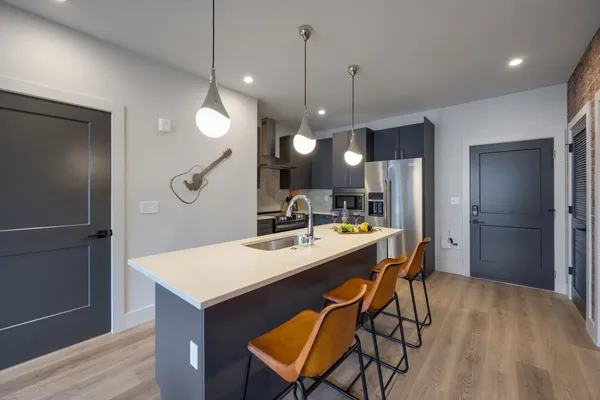 a large kitchen with a table and chairs