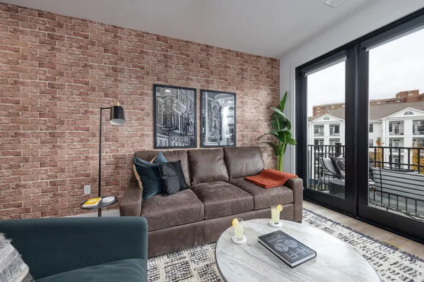 a living room with furniture and a floor to ceiling window