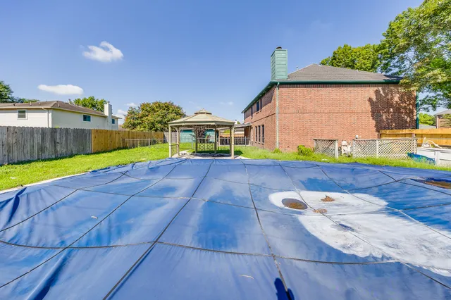 a view of an house with backyard space and balcony