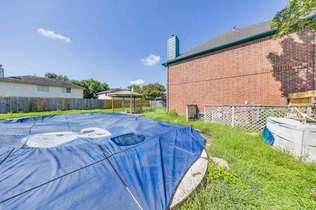 a view of yard from deck with patio