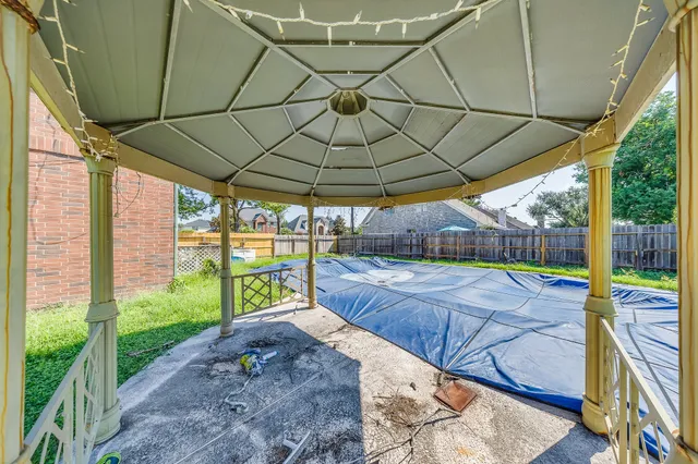 a view of a house with a yard and sitting area