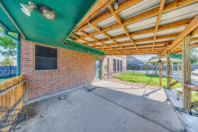 a kitchen with kitchen island granite countertop a sink counter top space appliances and cabinets