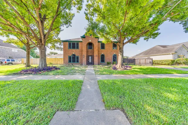 a front view of house with yard and green space