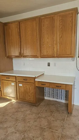 a stove top oven sitting inside of a kitchen