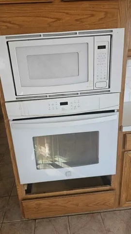 a view of a room with wooden floor and a window