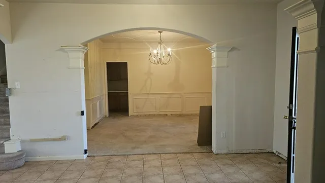 a view of hallway with livingroom and stairs