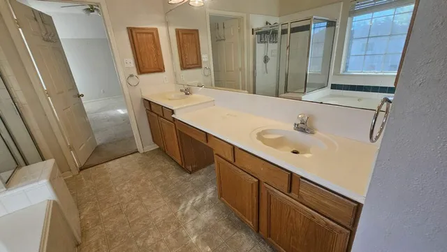 a bathroom with a double vanity sink and a mirror