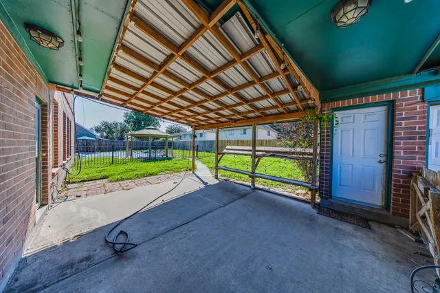 a view of a backyard with wooden fence