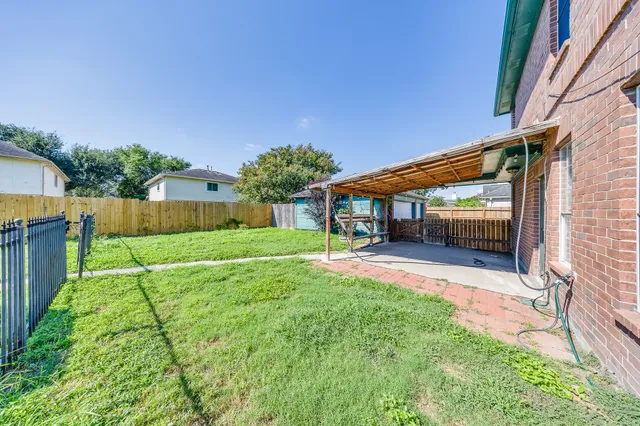a view of house with backyard and a patio
