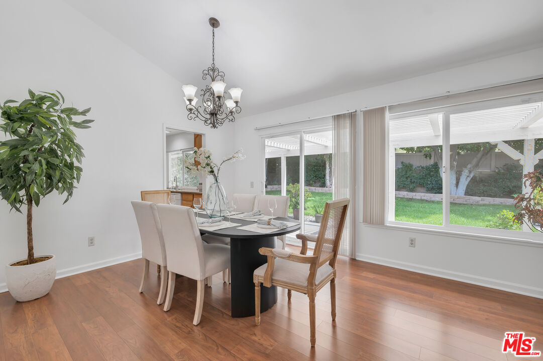 11700 Doral Avenue Porter Ranch, CA 91326 - Photo 13 of 65 a dining room with furniture potted plants and wooden floor