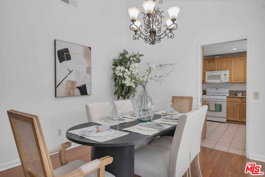 11700 Doral Avenue Porter Ranch, CA 91326 - Photo 14 of 65 a view of a dining room with furniture and chandelier