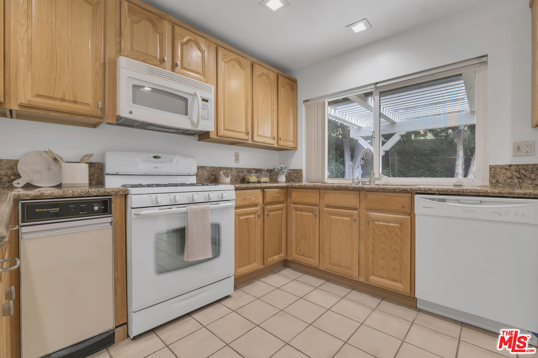 11700 Doral Avenue Porter Ranch, CA 91326 - Photo 20 of 65 a kitchen with cabinets appliances and a sink