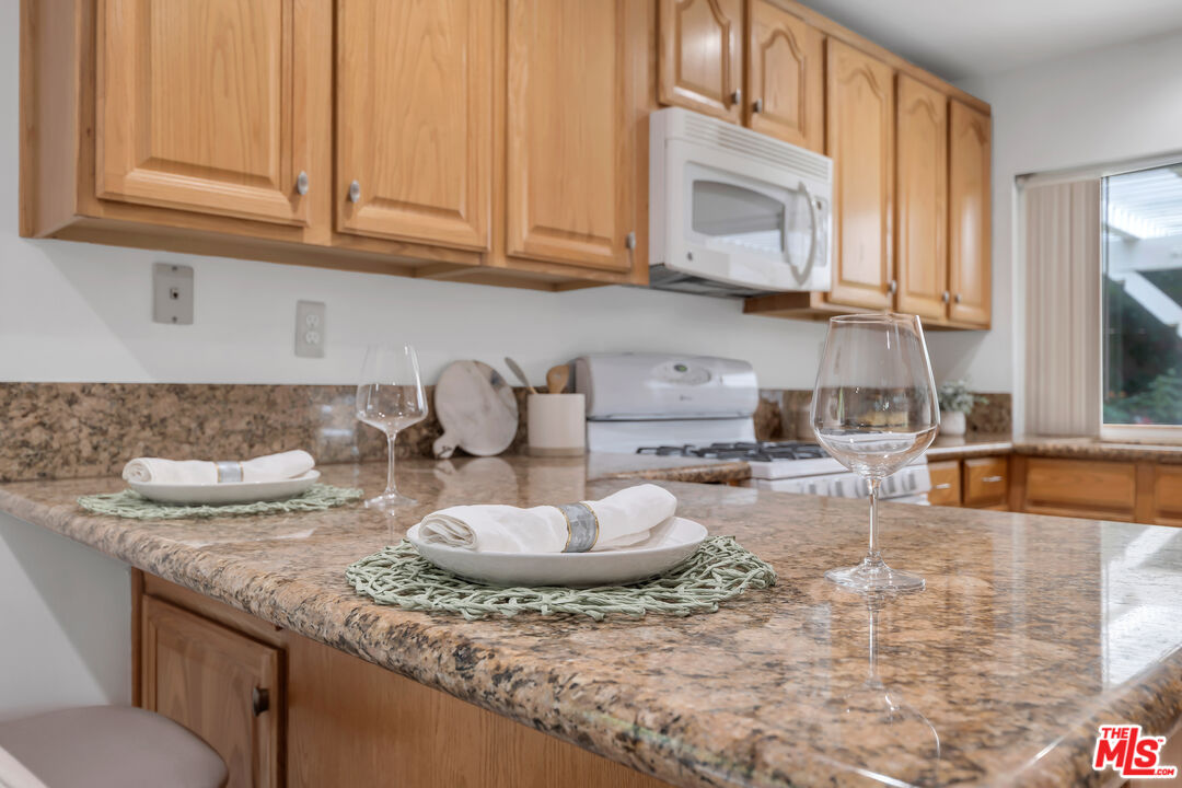 11700 Doral Avenue Porter Ranch, CA 91326 - Photo 23 of 65 a kitchen with a sink and cabinets