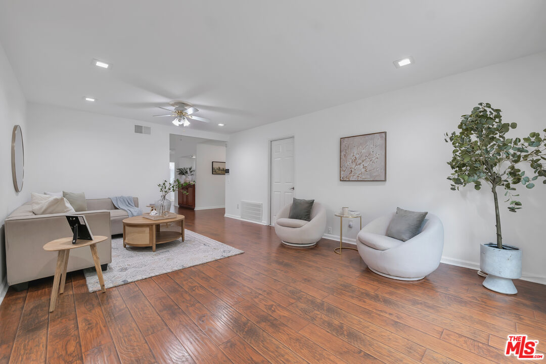 11700 Doral Avenue Porter Ranch, CA 91326 - Photo 24 of 65 a living room with furniture and a potted plant
