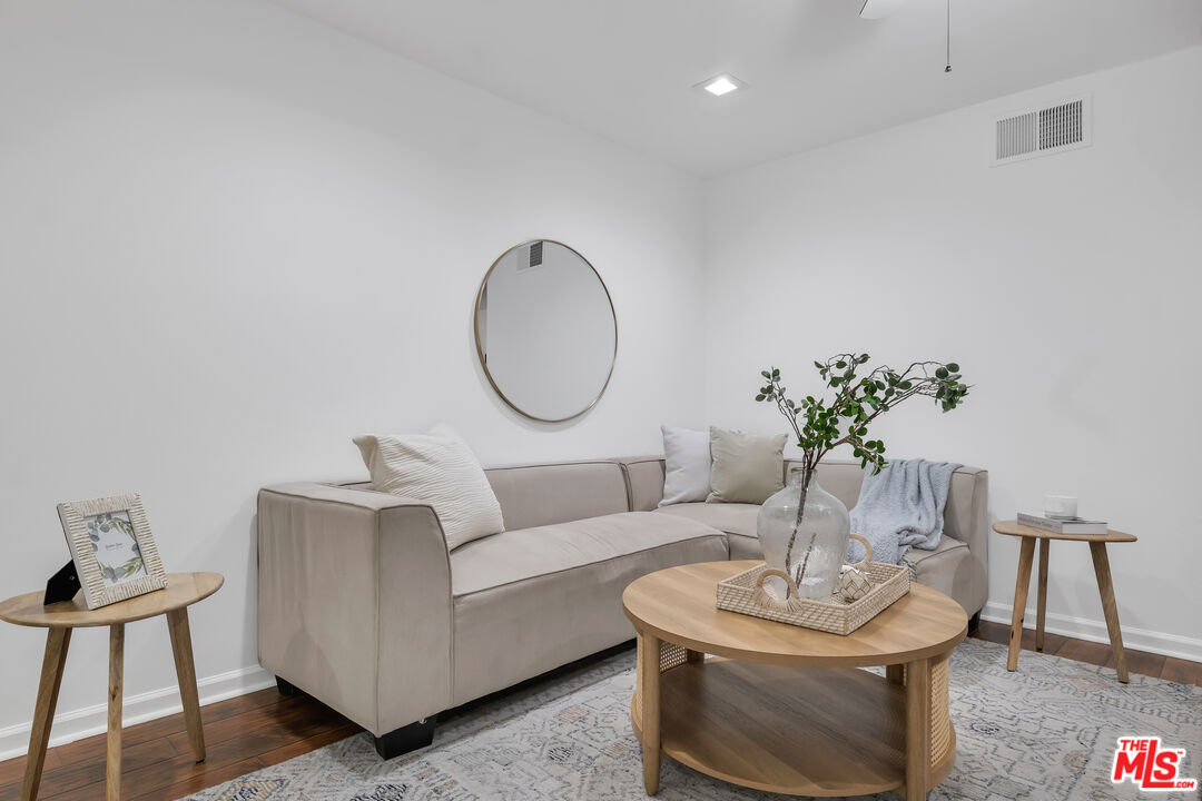 11700 Doral Avenue Porter Ranch, CA 91326 - Photo 27 of 65 a living room with furniture a potted plant and a lamp
