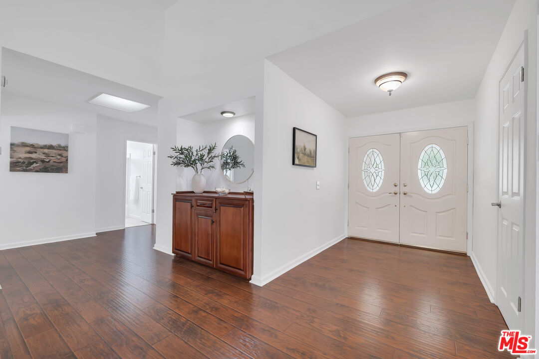 11700 Doral Avenue Porter Ranch, CA 91326 - Photo 30 of 65 an empty room with wooden floor and window